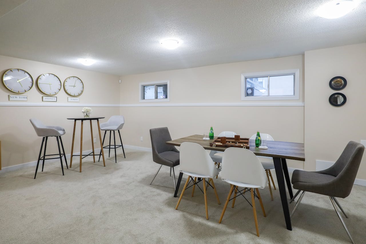 hero-img-02 Stylish and elegant basement dining and living area with minimalist decor in Edmonton, Canada.