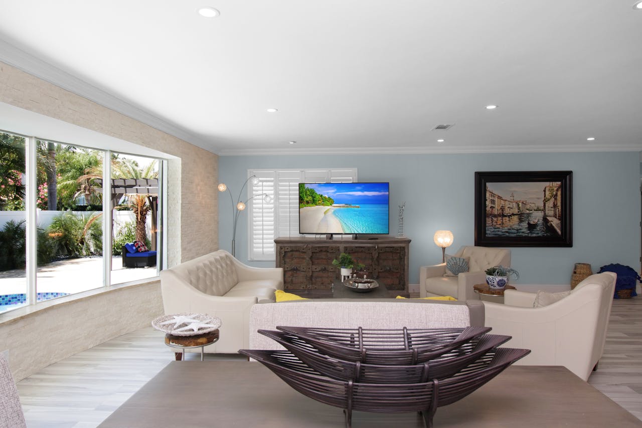 gallery-4 Spacious living room with modern furniture and a scenic view from a large window.