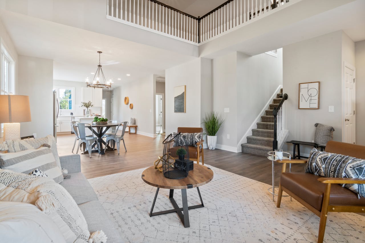 services-01 Bright and elegant open concept living room featuring modern furniture and decor.